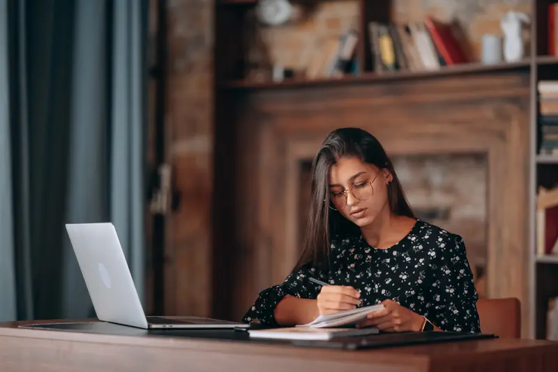 Professional making notes on tax changes at a desk