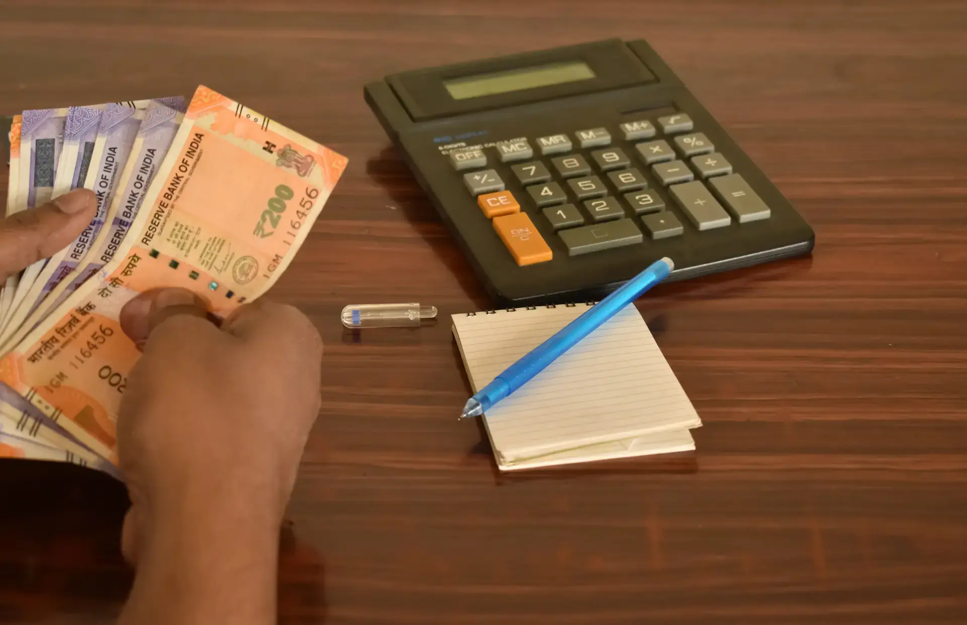 Person calculating home loan eligibility with Indian currency