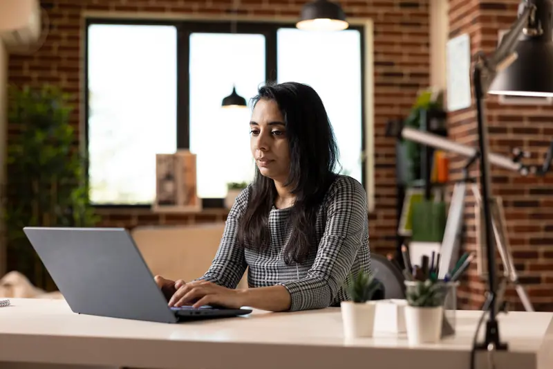 Woman reviewing insurance premium details on a laptop