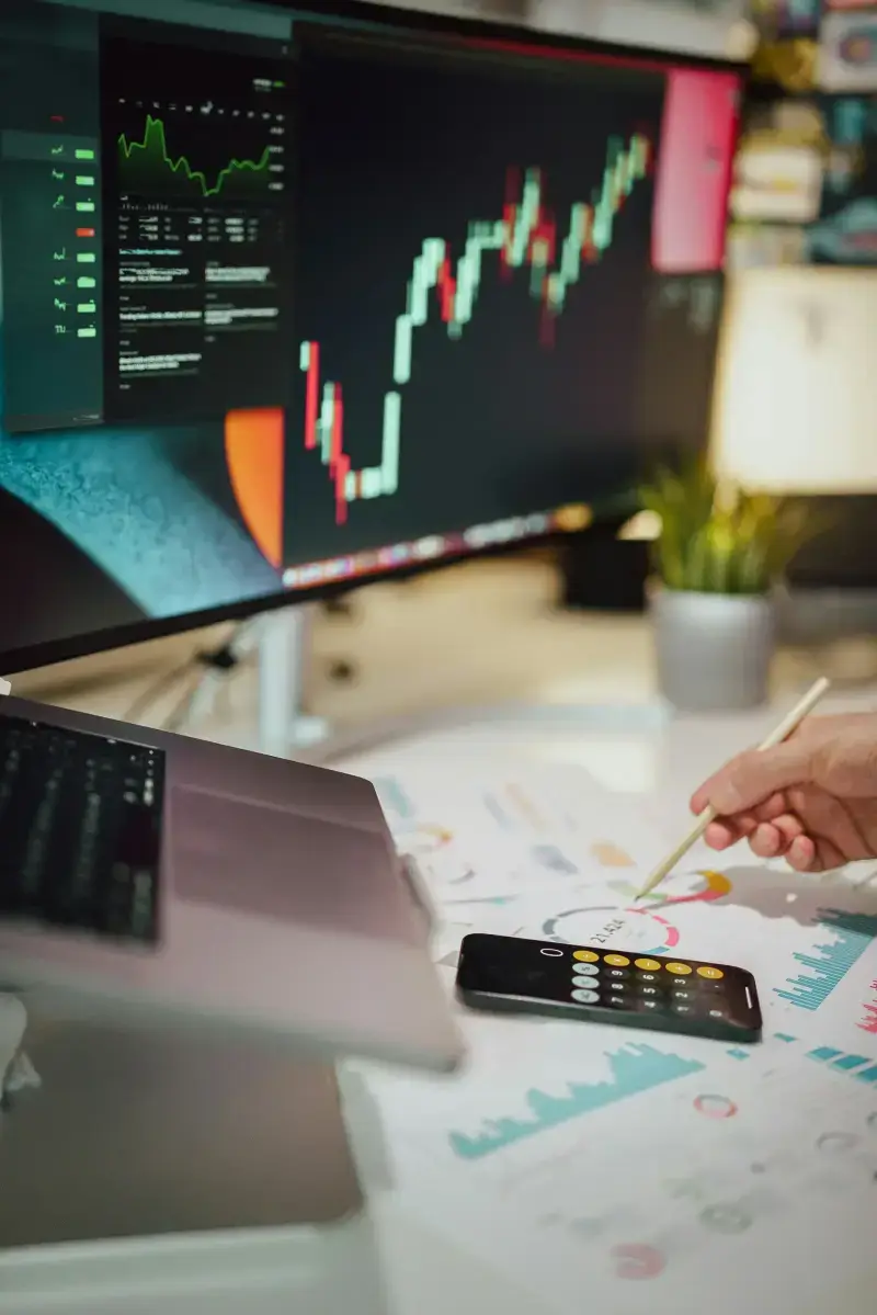 Analyst reviewing trading charts on large monitor