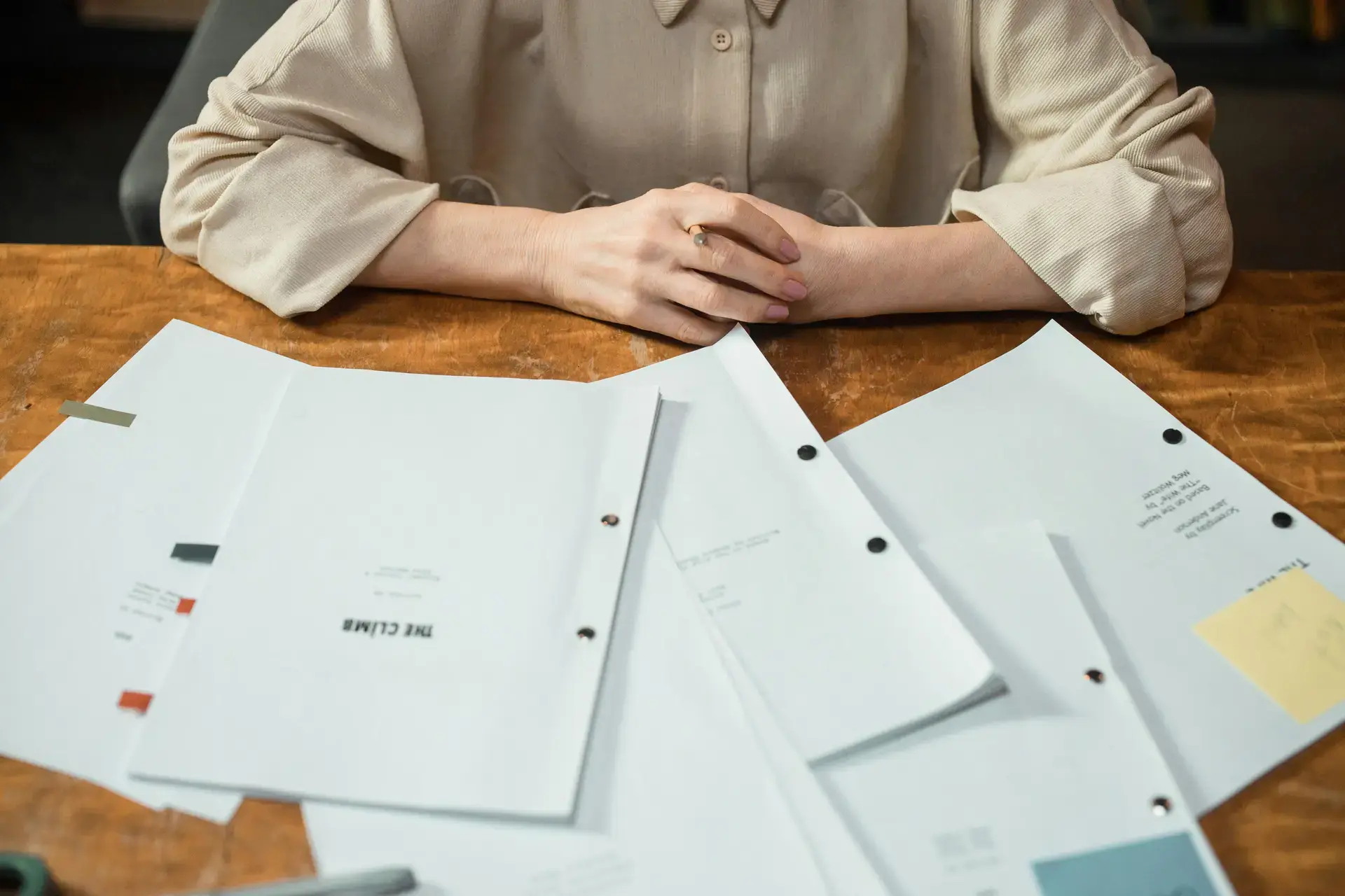 Person reviewing financial documents at a desk